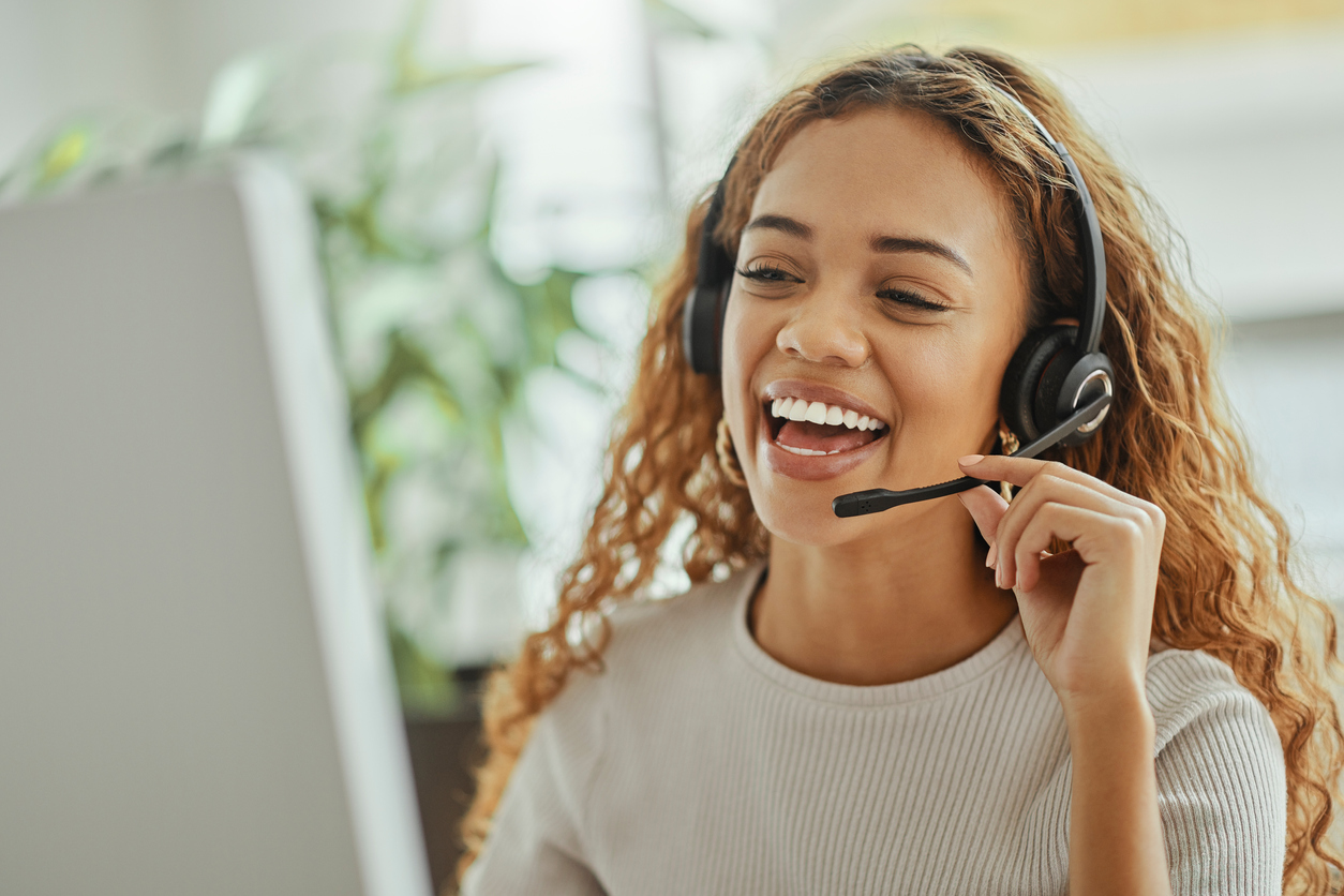 Smiling woman using new customer service solutions to help a customer solve a problem.