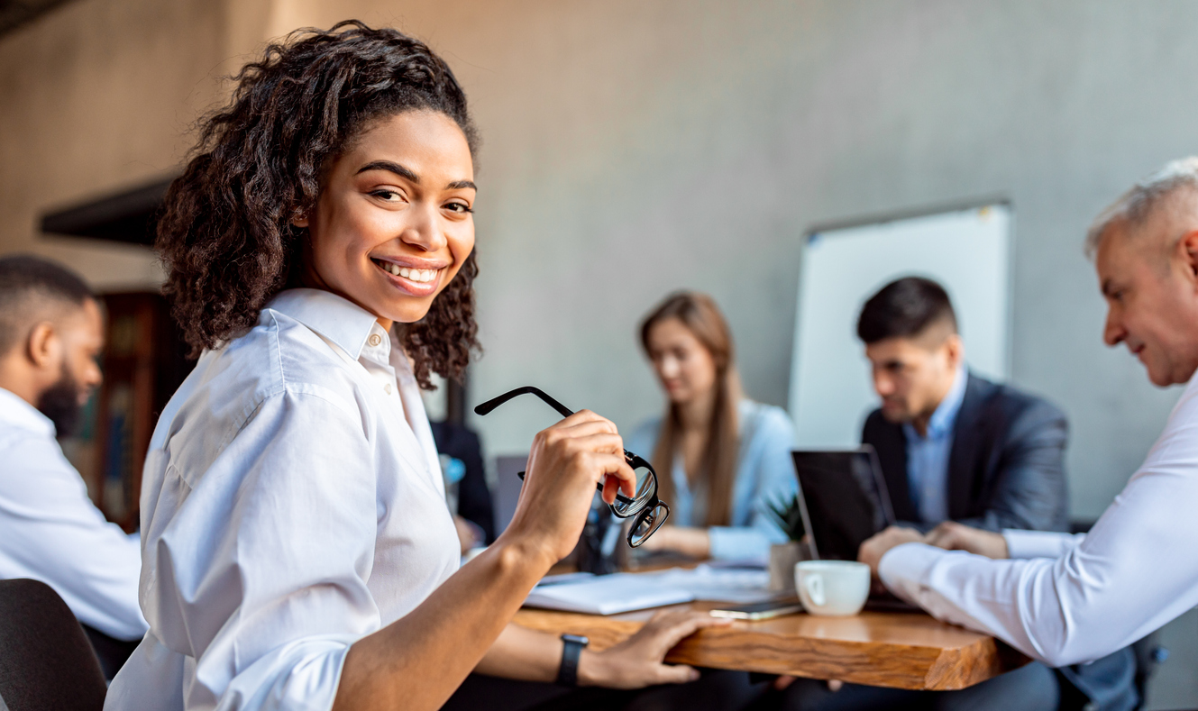 Female employee smiling during a business meeting
