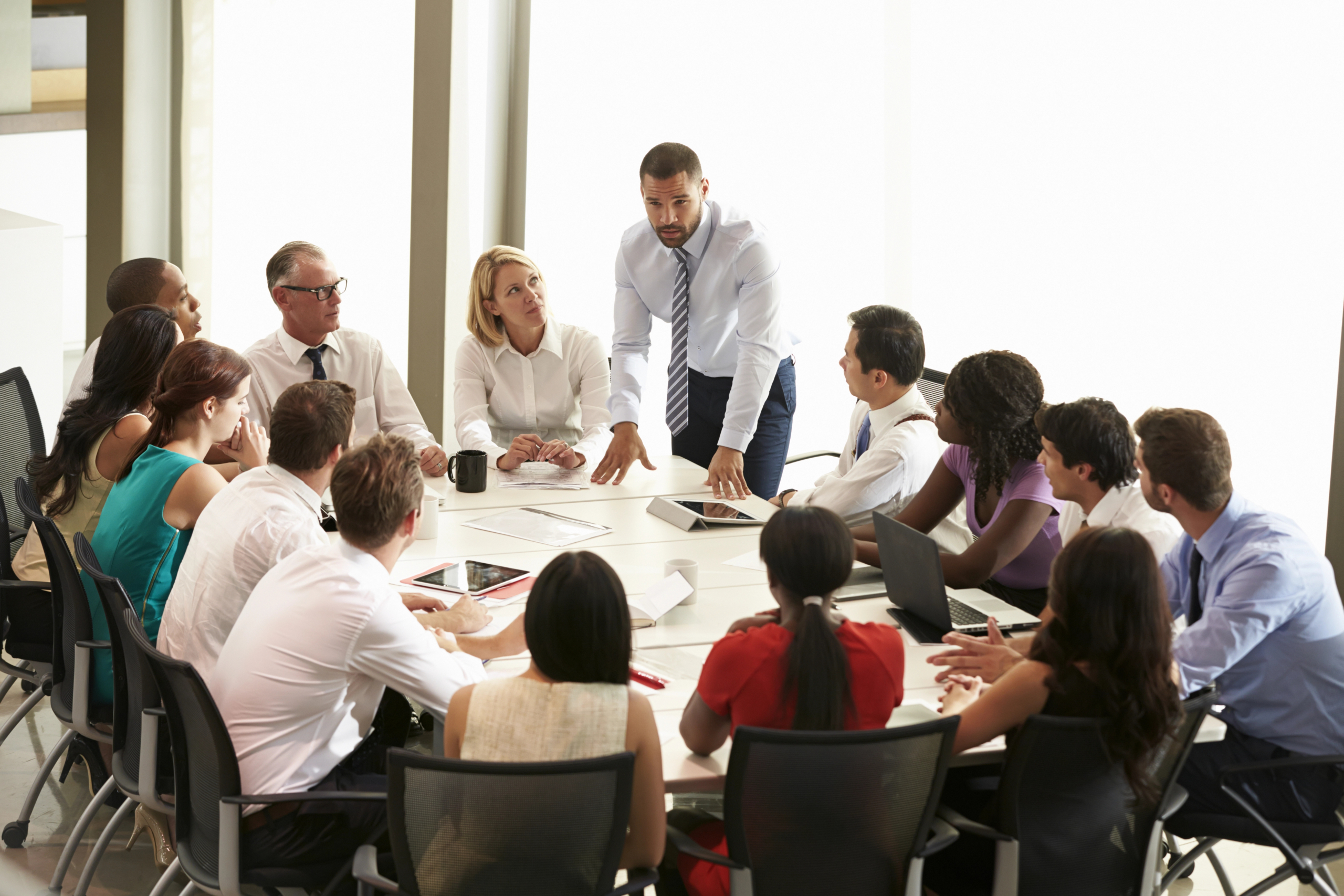 businesspeople discussing an integrated communication campaign in a boardroom.