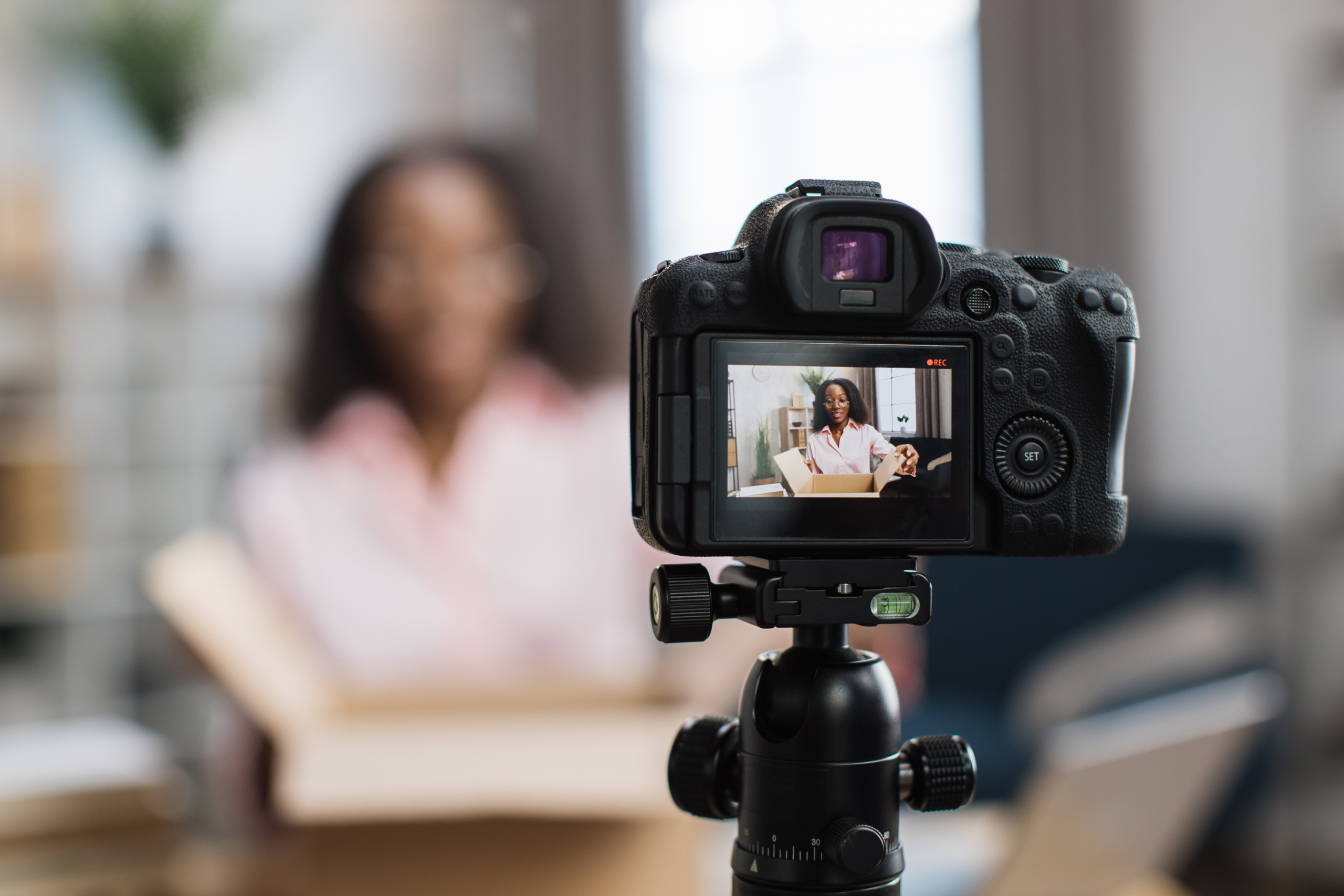 woman filming a video testimonial to boost demand generation