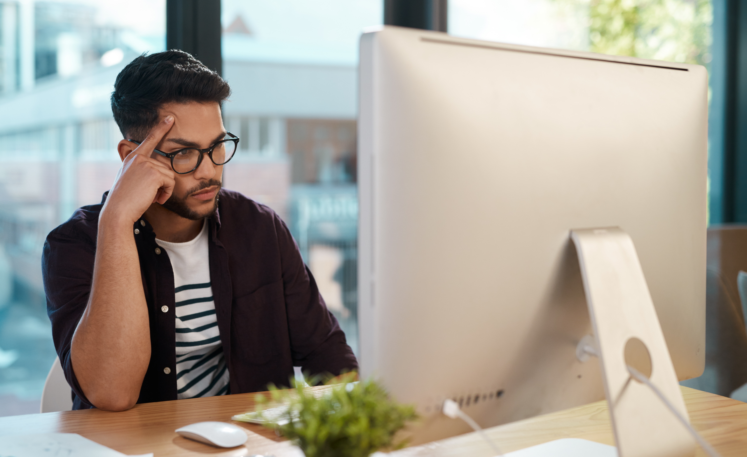 man sits at computer thinking about lead generation mistakes