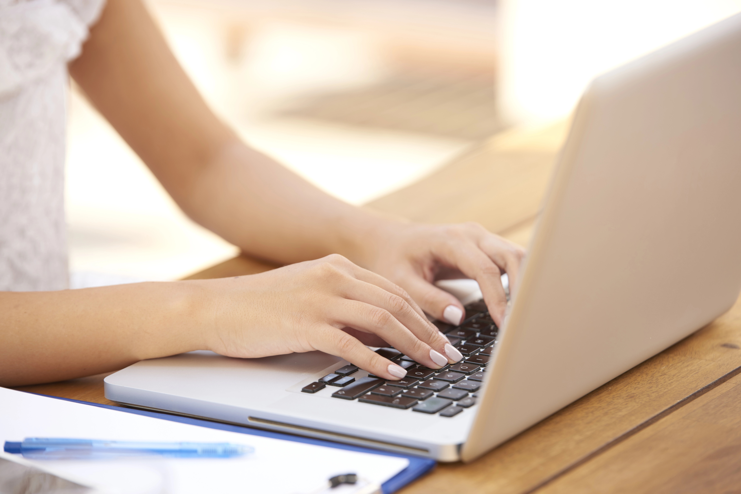 side view of business woman using laptop computer to learn about content marketing for SaaS