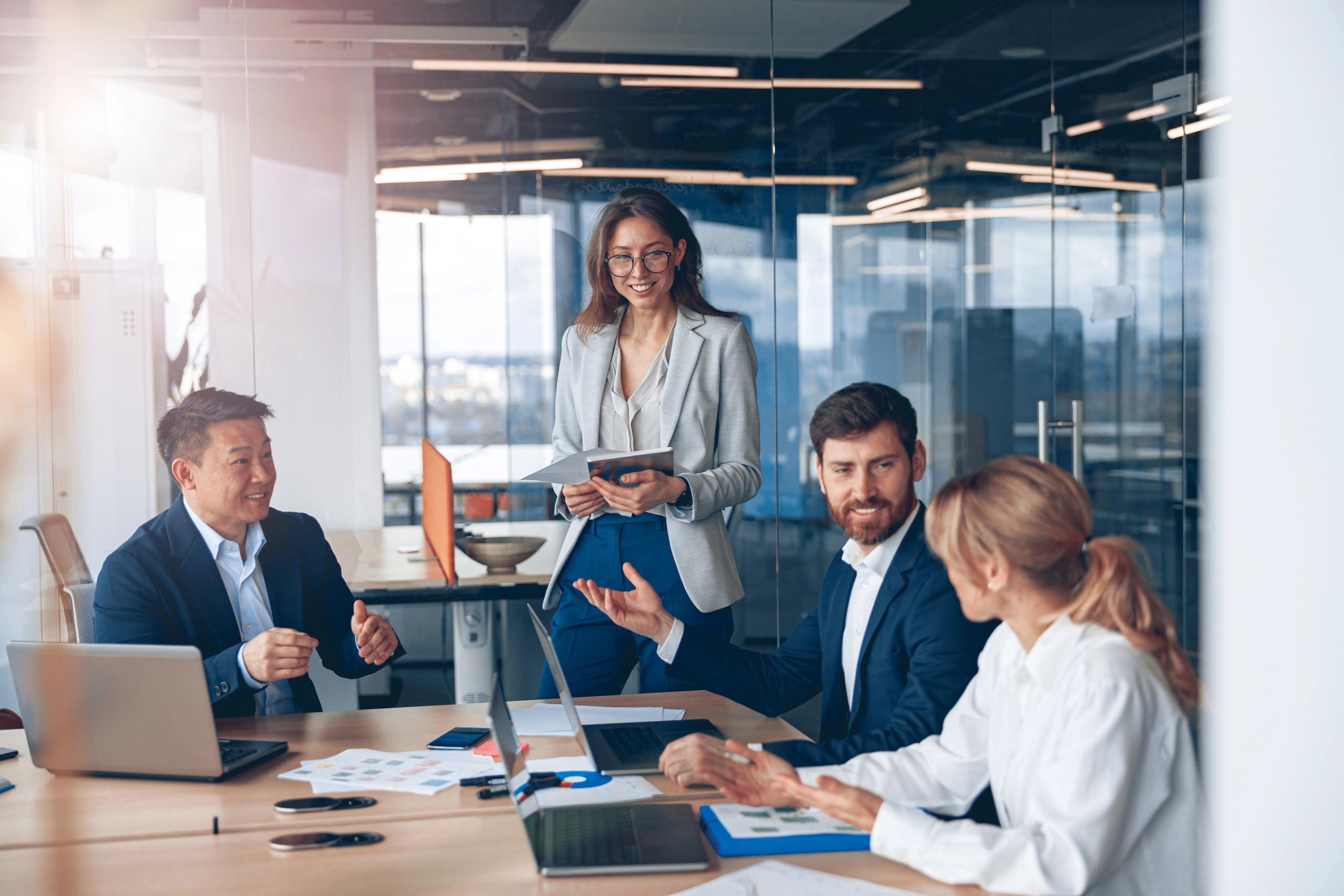 group of business people sit at desk in office and review growth after using sales automation tools