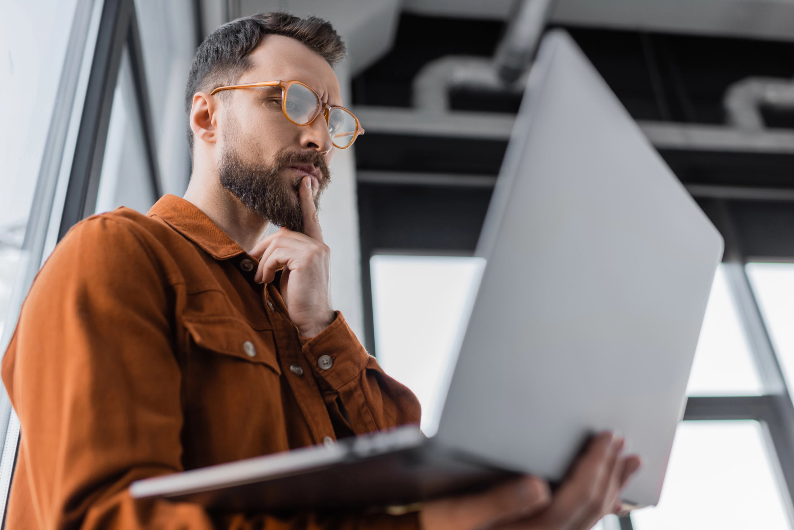low angle of businessman learning about customer lifetime value marketing on laptop computer