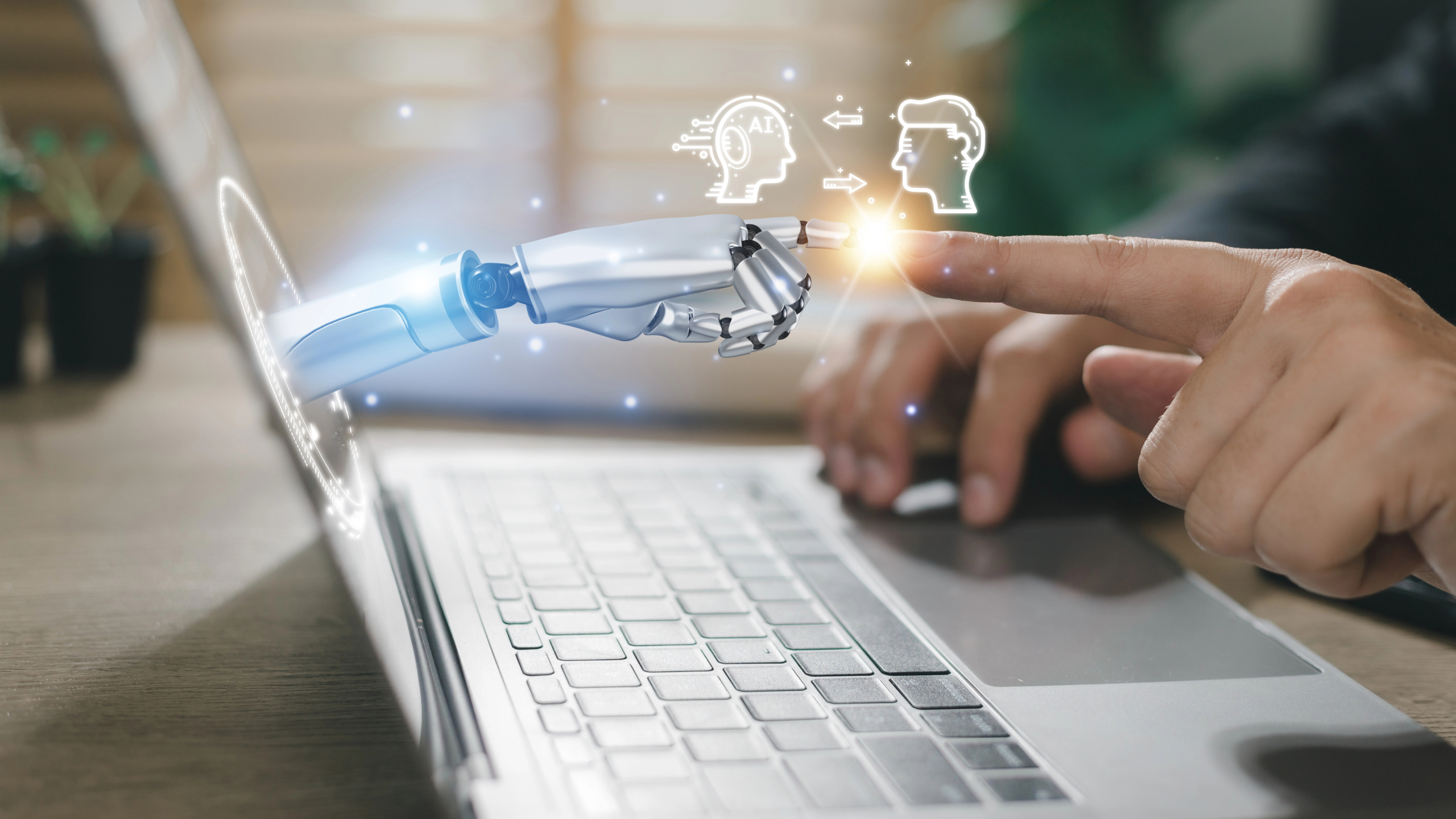 hands of robot and human touching through computer screen to represent how to choose a CMO marketing automation vendor