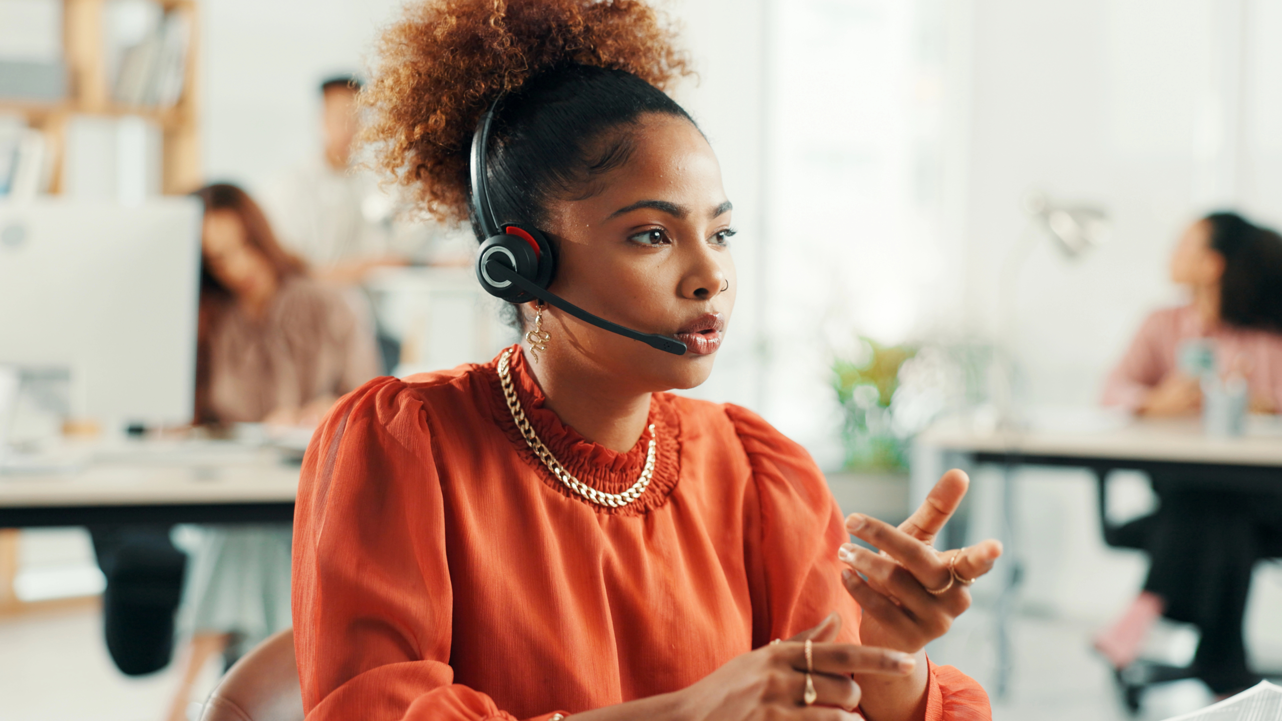 A woman on a headset managing B2B appointment setting calls at her desk.